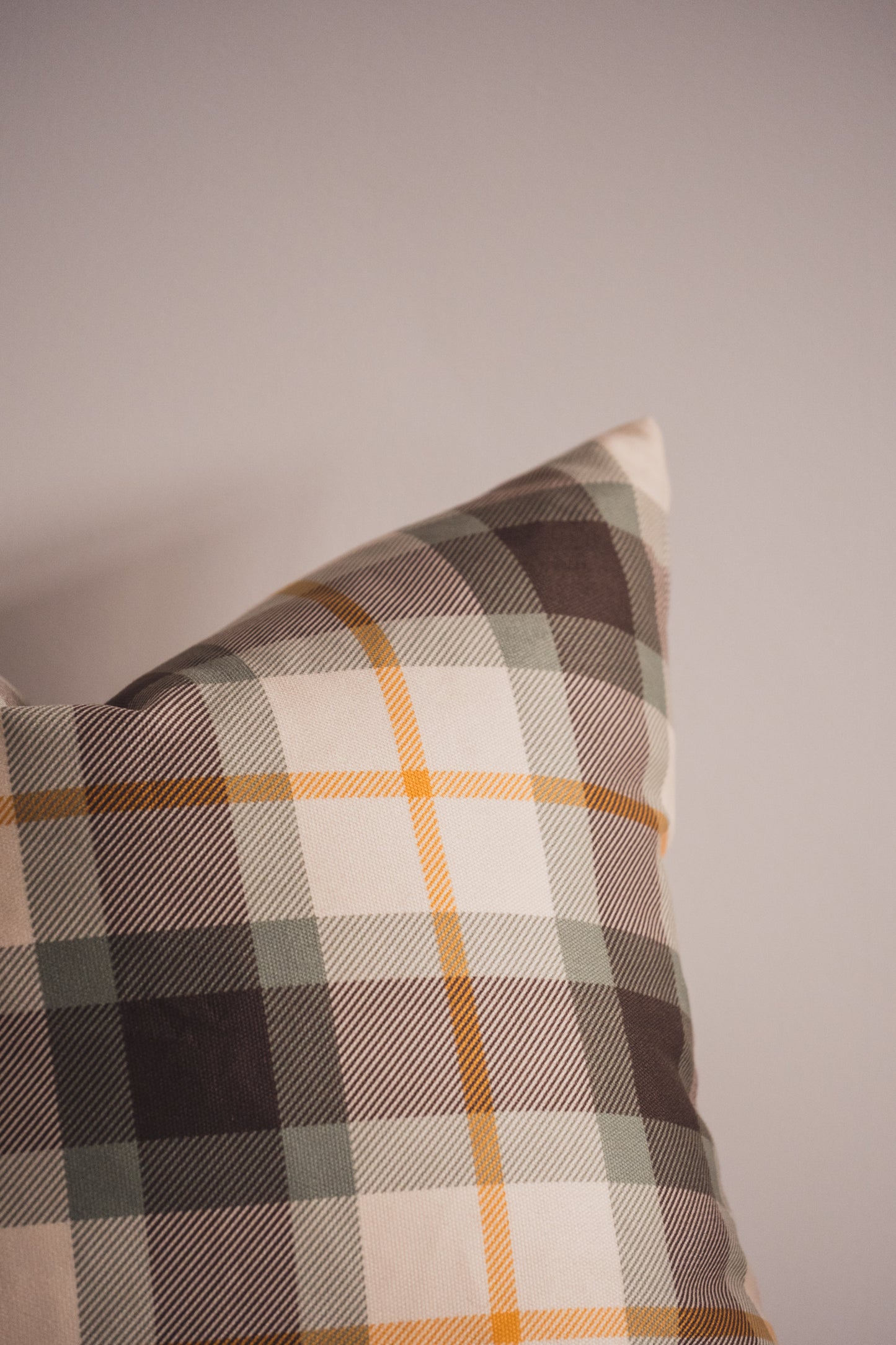 Close up of the Lil & Dot Moss Plaid Cushion.