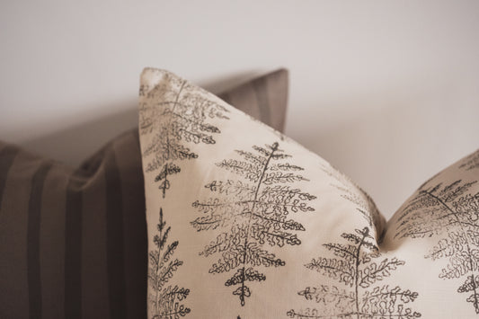 Close up of the Lil & Dot hand illustrated Fern Cushion in Moss green and the Pinterly Stripe Cushion.
