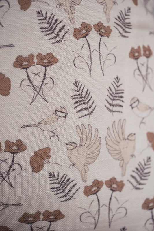 A close up of the Lil & Dot hand illustrated Birdsong Cushion in Mocha.