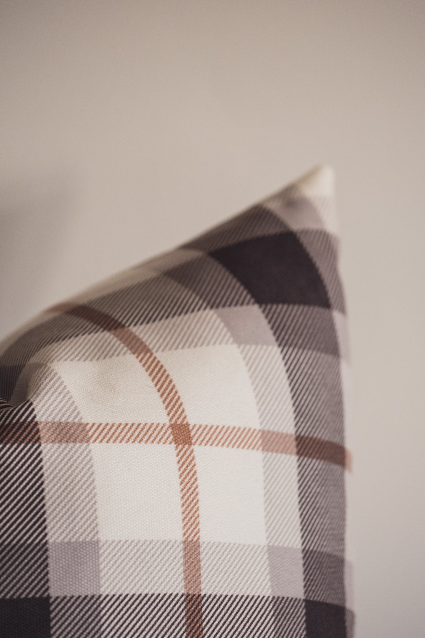 A close up of the Lil & Dot Mocha Plaid Cushion.