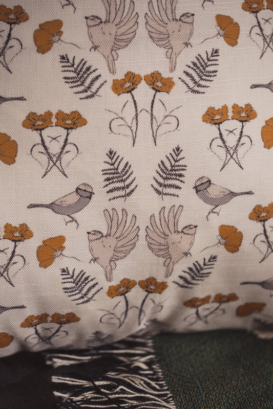 A close up of the Lil & Dot hand illustrated Birdsong Cushion in Ochre.