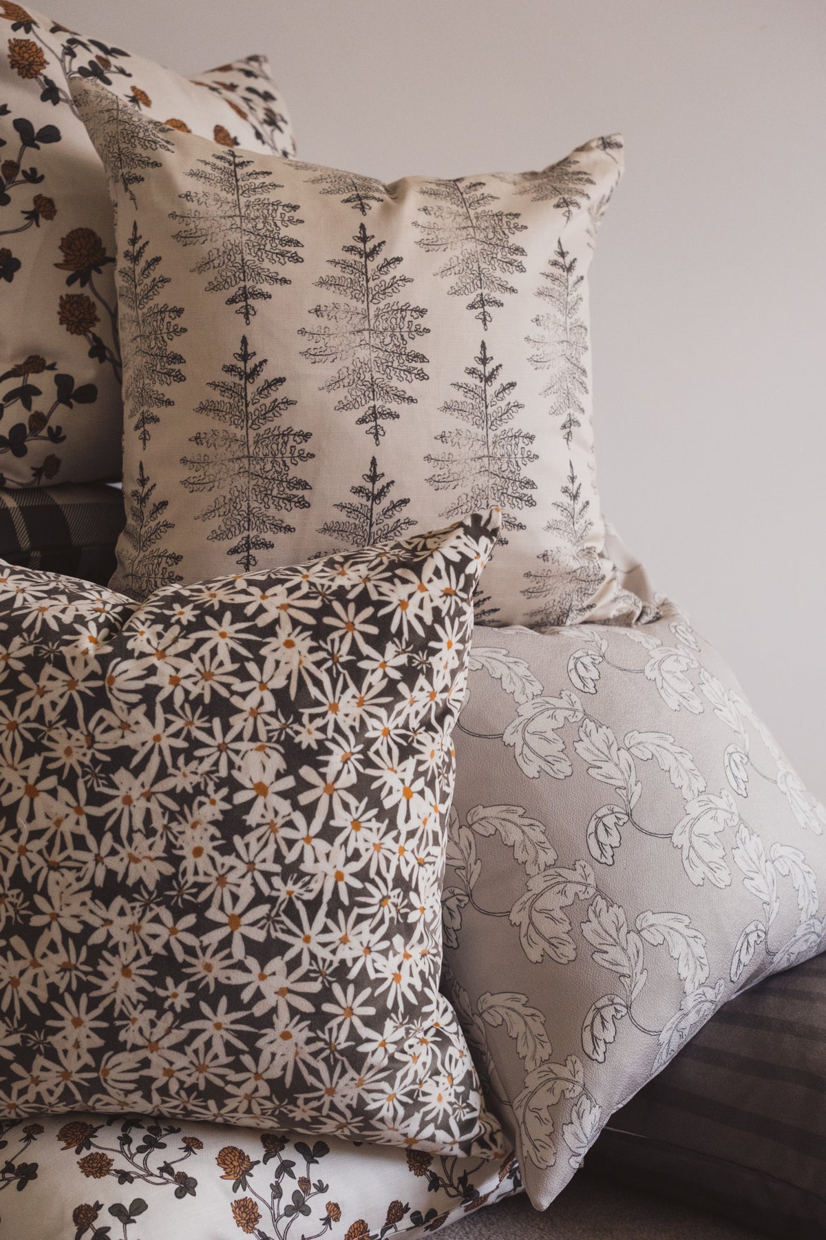 The Lil & Dot Cushion Collection including the Daisy Cushion, Acanthus Cushion, Fern Cushion & Clover Cushion.
