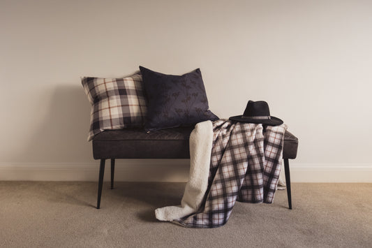 A wide shot of the Mocha Plaid Cushion and the Mocha Plaid Throw with the Gathered Stems cushion by Lil & Dot.
